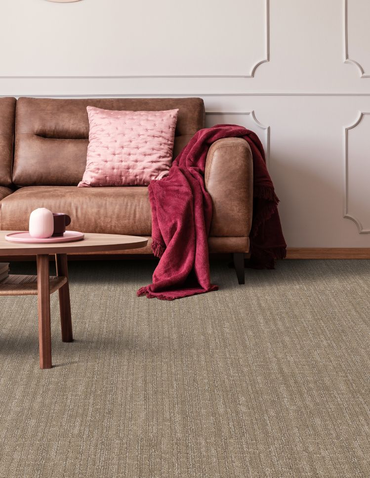 brown textured carpets in a stylish living room with brown leather couch and pink accents