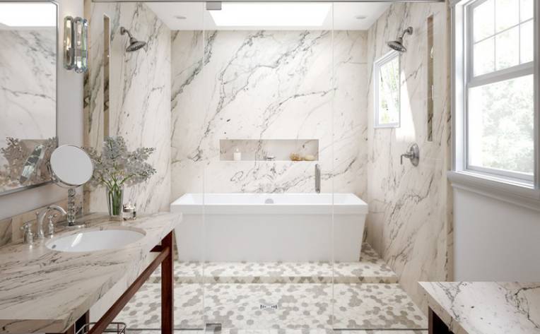 marble attache calacatta hex mosaic flooring by Daltile in bathroom with marble shower and bathtub.